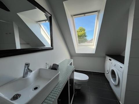 a bathroom with a sink and a washing machine at Møllevej in Hjørring