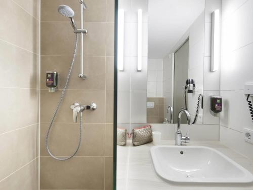 a bathroom with a shower and a sink at Ibis Styles Konstanz in Konstanz