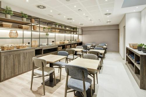 a row of tables and chairs in a restaurant at Sercotel Ayala in Bilbao