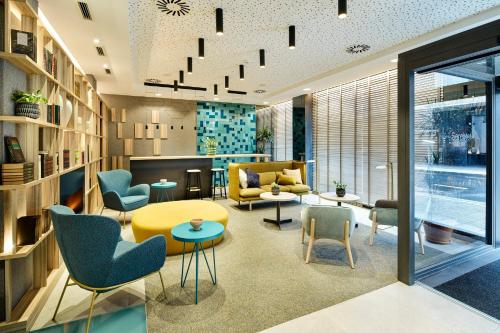 a living room with chairs and a table at Sercotel Ayala in Bilbao