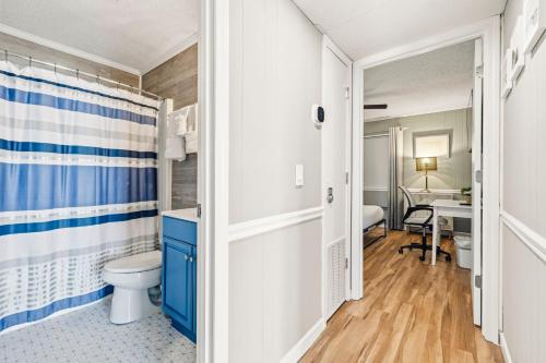 a bathroom with a toilet and a sink at The Beach Is Back in Myrtle Beach