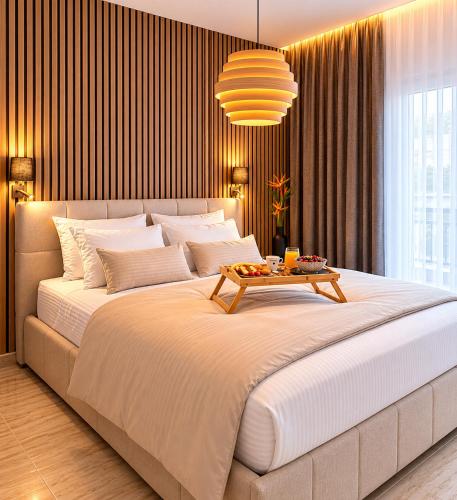 a large bed with a table on top of it at Belvedere Penthouse Suite in Tríkala