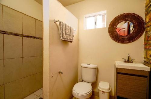 a bathroom with a toilet and a sink and a mirror at Beach Studio 7 in San Felipe