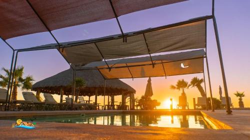 a woman laying on the ground next to a swimming pool at Beach Studio 7 in San Felipe