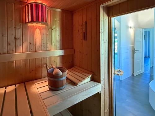 a sauna with a pot sitting on a shelf at Schlei Resort Marina Hülsen in Kosel