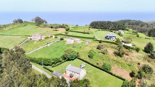 an aerial view of a house on a hill at The Cliffs - Casa Cadaval in Santa Marta de Ortigueira