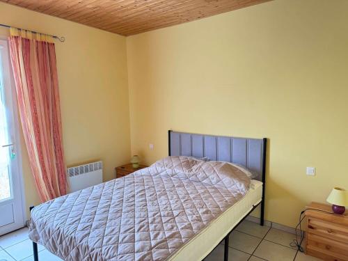 a bedroom with a bed and a window at La Pierre Lotie in Saint-Denis-dʼOléron
