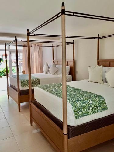 two beds in a hotel room with twothirdsessions at Fond Doux Eco Resort in Soufrière