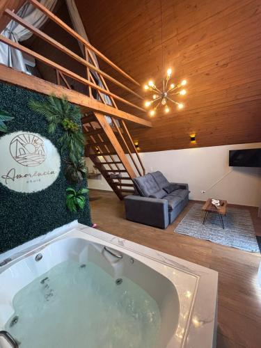 a large bath tub in a room with a staircase at Amorência Chalé Luz da lua in Campo Largo