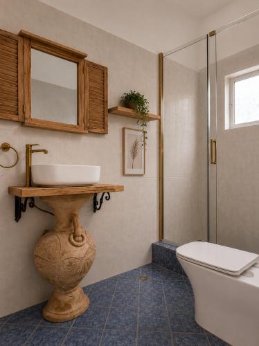 a bathroom with a sink and a toilet at Casa Boha Garden in Dhërmi