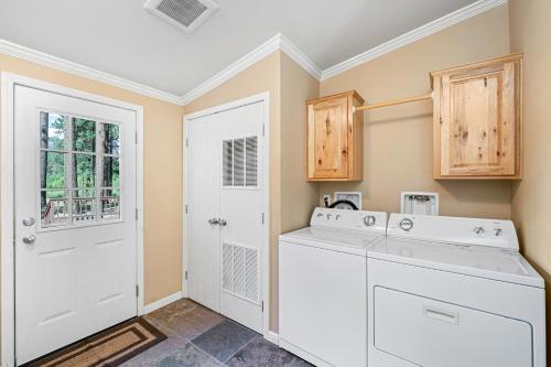 a white laundry room with a washer and dryer at 200 Acres, River Access: 'Feather House' in NorCal in Sloat