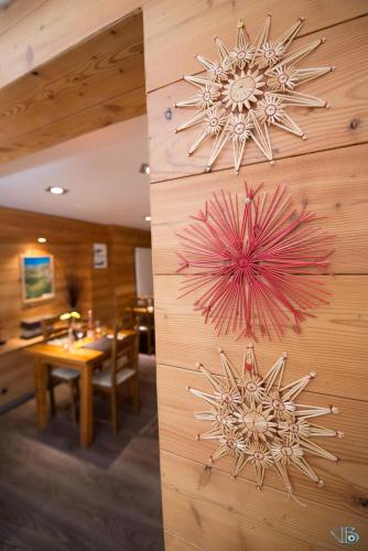 two artworks on the wall of a restaurant at Chalet de Lanza in Abriès