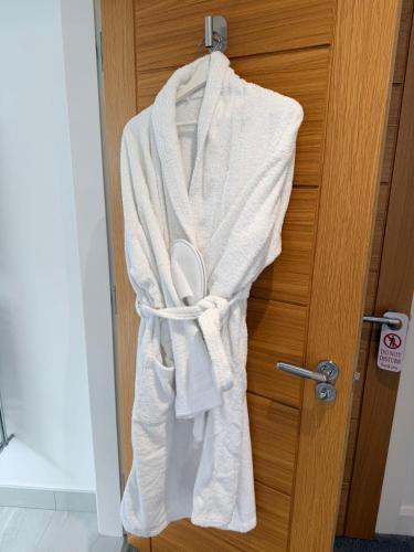 a robe is hanging on a door at Ardbrin Lodge Guest Accommodation in Dunadry