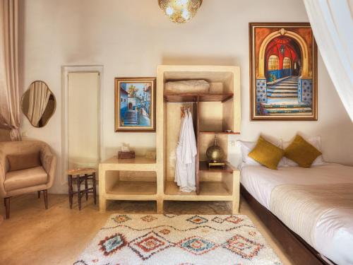 a bedroom with a bunk bed and a chair at Riad El Maâti in Rabat