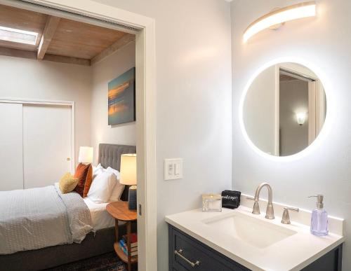 a bathroom with a sink and a bedroom with a bed at 3890 Cypress Rest in Pebble Beach