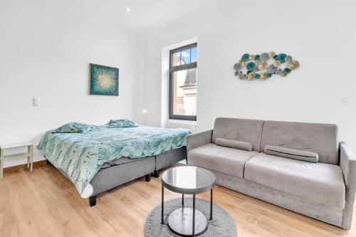 a living room with a couch and a bed at Résidence Welter Luxembourg in Luxembourg