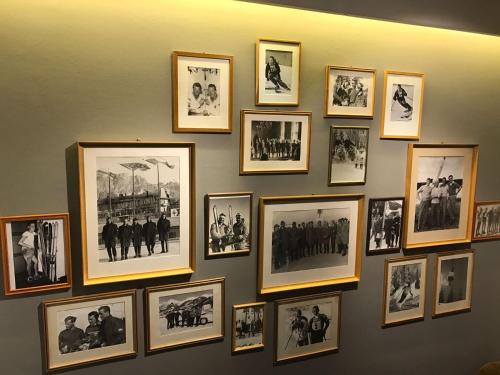a wall with framed pictures on a wall at Pension Hinterseer in Kitzbühel