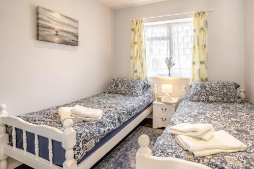 a bedroom with two beds and a window at 2 Bed in Mumbles oc-hh505 in The Mumbles