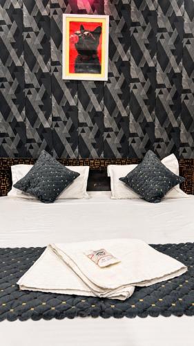 a bedroom with a bed with a towel on it at Hotel Madhav Inn in Lucknow