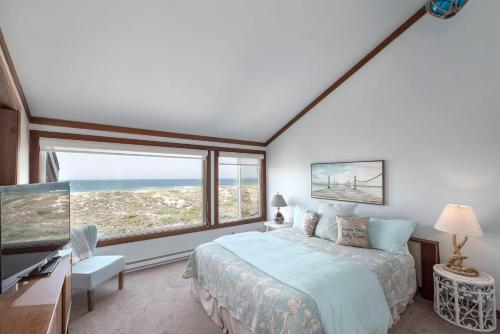 a bedroom with a bed and a large window at 3823 Sand Dollar House in Moss Landing