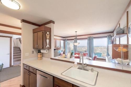 a kitchen with a sink and a living room at 3823 Sand Dollar House in Moss Landing