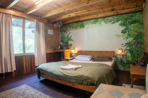 a bedroom with two beds in a room with wooden ceilings at Aloha Riverside in Kasol
