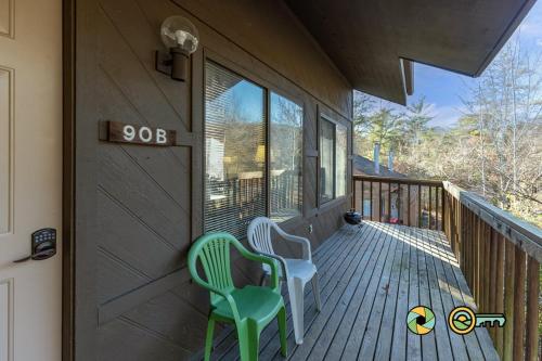 two chairs sitting on the front porch of a house at Senedo Springs Duplex #90B in Basye