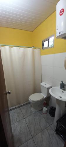 a bathroom with a toilet and a sink at Olivia in Paysandú