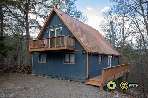 a blue house with a deck on top of it at 16 Deloris Road: Coppertop Chalet in Basye