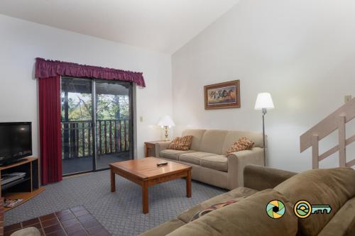 a living room with a couch and a table at Senedo Springs Condo #2-301 in Basye