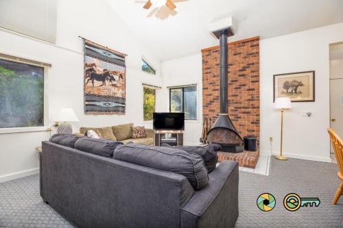 a living room with a couch and a fireplace at Senedo Springs Duplex #98A in Basye
