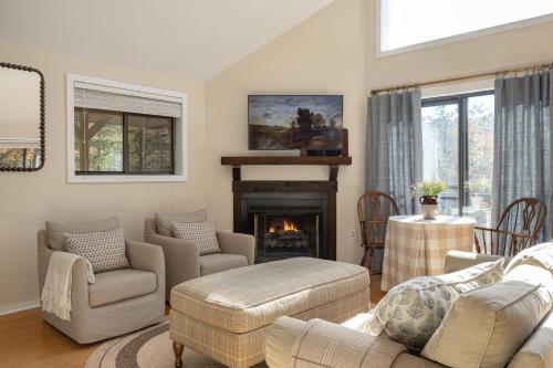 a living room with a couch and chairs and a fireplace at 210 Nelson Way: Par Pine Lodge in Basye