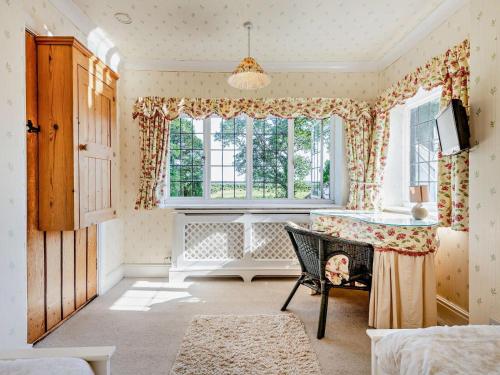 a living room with a table and a window at 4 Bed in Ringwood oc-92557 in Burley