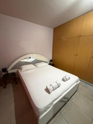 a bedroom with a large white bed with two towels at Verga Olive Grove Studio in Kalamata