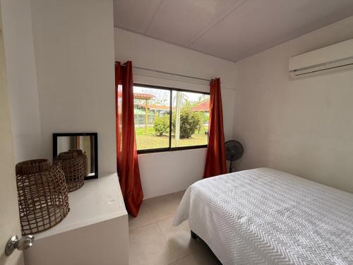 a bedroom with a bed and a window at Casa Melda Walk to the Beach & Gandoca-ManzanillO in Manzanillo