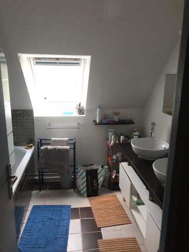 a bathroom with a sink and a tub and a window at Single-storey house in Saint-Cyr in Saint-Cyr-sur-Loire