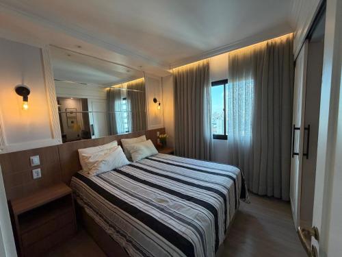 a bedroom with a large bed and a large mirror at Hotel Inter Jardins UH-2310 in São Paulo