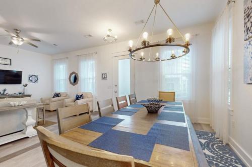 a dining room and living room with a dining table at New-Build with Pool Walk to Beach in Santa Rosa Beach