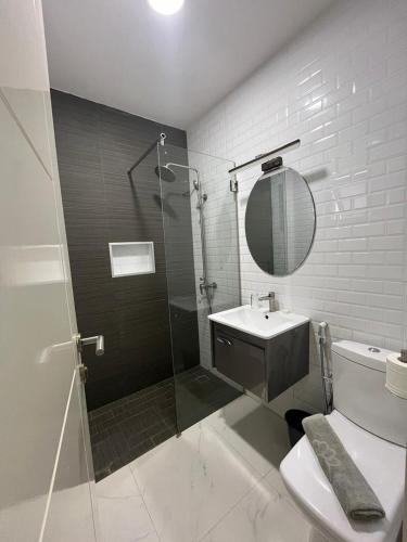 a bathroom with a shower and a toilet and a sink at Résidence Cap Sud Ngor Almadies in Dakar