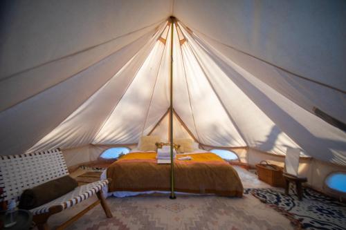 a bedroom with a tent with a bed in it at Gatherwild Ranch in Germantown