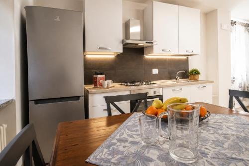 a kitchen with a table with a bowl of fruit on it at A Casa di Laura in Parella
