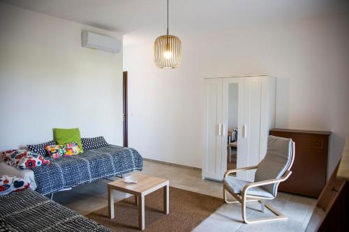a living room with a couch and a chair at Villa Santa Lucia in Noto