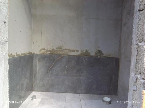 a room with a wall that is being remodeled at Kamp Suad in Bihać