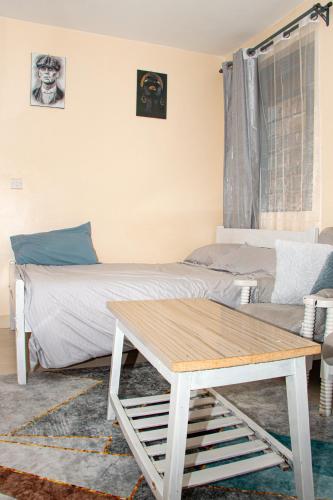 a bedroom with a bed and a coffee table at Delore suits in Ongata Rongai 