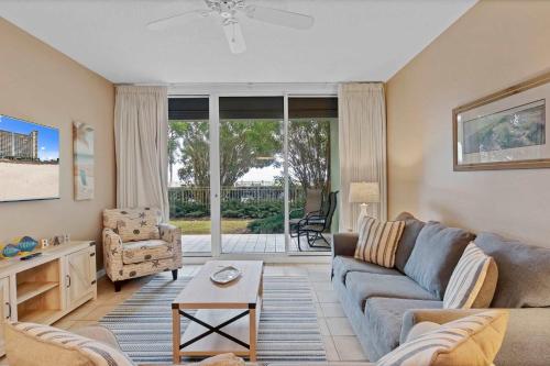 a living room with a couch and a table at 3BR 4BA Ground Floor Gulf Getaway in Gulf Shores