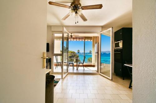 a kitchen with a ceiling fan and a view of the ocean at Mer et plage Standing Presta in Cannes