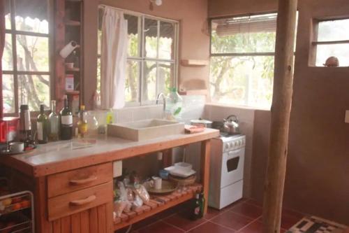 a kitchen with a counter with a sink and a stove at Amor pisciano 1 in Salinas