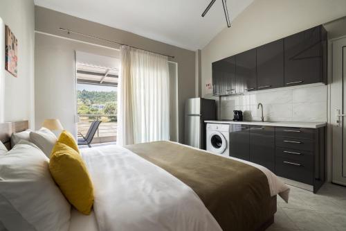 a bedroom with a large bed and a kitchen at Sakis in Polychrono