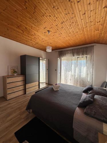 a bedroom with a large bed and a television at Apartments Angela Rab in Supetarska Draga