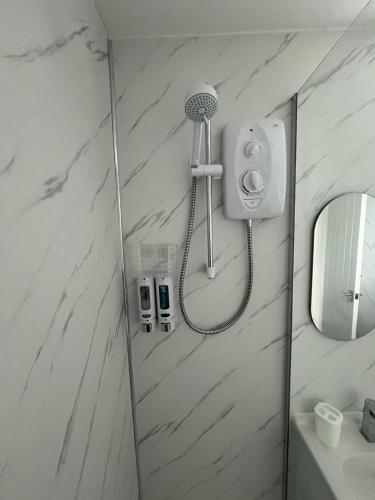 a bathroom with a shower and a mirror at 39 Perran View Your Home Away from Home in Cornwall in St. Agnes